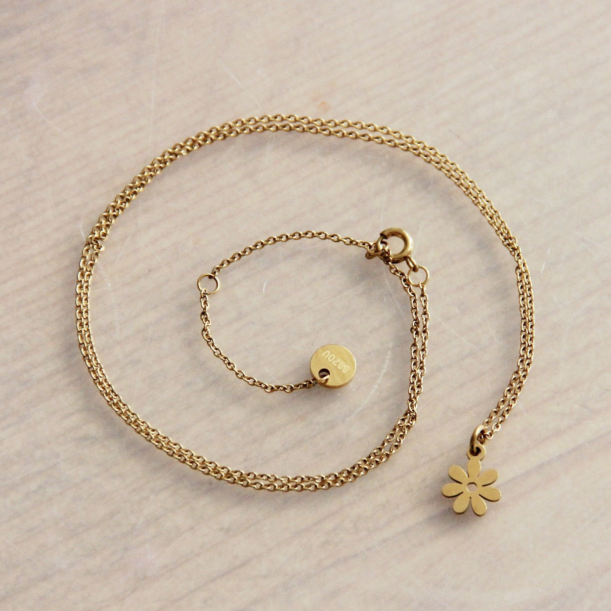 RVS fijne ketting met mini bloem - goud
